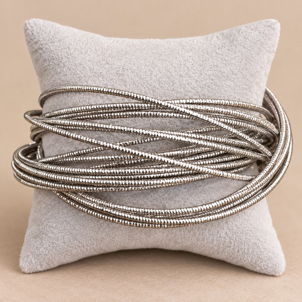 Large stack of thin silver-tone bangle bracelets